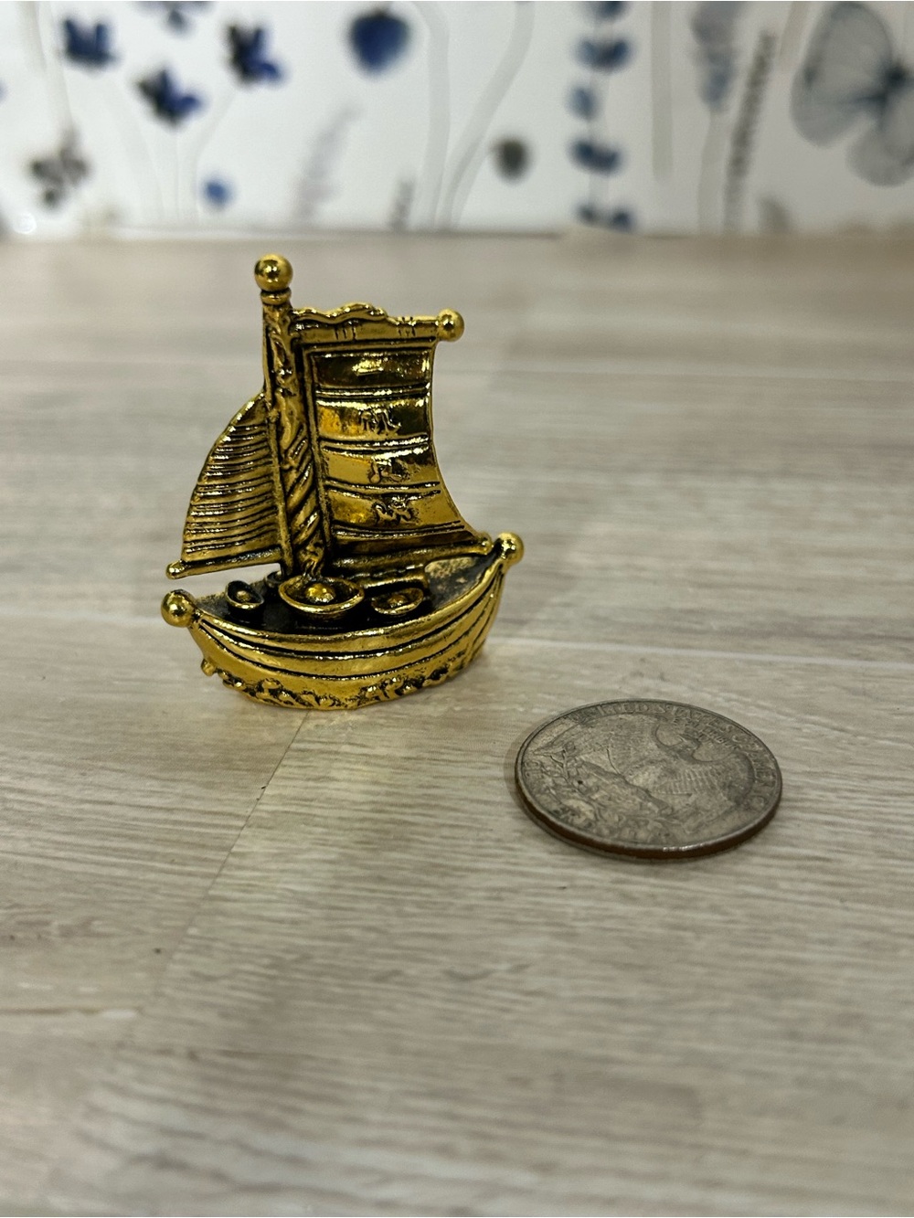 A brass sailboat trinket.